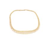 A 9ct bi-coloured gold fringe necklace, featuring an array of articulated and textured fringes in