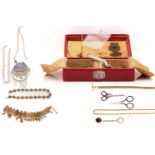 A red leather jewellery box containing a gilt metal watch chain, a gold plated twisted rope necklace