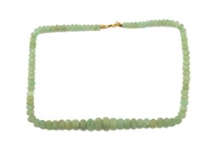 A carved emerald bead necklace, comprising a string of ninety-one reeded emerald beads in pale green
