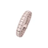 A three-row diamond bracelet, scintillates with an array of graduated baguette diamonds in the