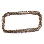 An early 20th-century muff chain, with fancy links and a later replaced clasp, metal unmarked,