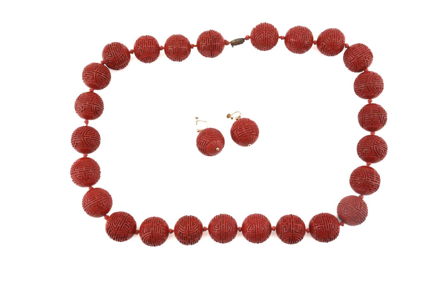 A Chinese lacquer carved bead necklace and matching earrings; the necklace consists of twenty-five
