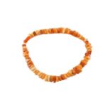 A multi-coloured amber bead necklace, strung with rectangular beads of various translucencies,