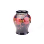 A large William Moorcroft baluster vase in the Pomegranate pattern, tube-lined decoration on a