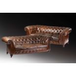 A matched pair of 'Country House' weathered brown hide three-seat "Chesterfield " settees, late