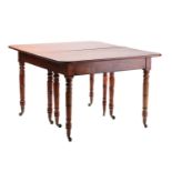 A George IV ebony strung mahogany extending dining table with telescopic carriage and three-leaf