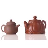 A 20th-century Chinese Yixing teapot, 9.5 cm high x 16 cm wide, together with another smaller, 8