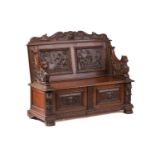 A Victorian 'Jacobethan' carved oak box settle/ hall bench with Elizabethan scenes to the panelled