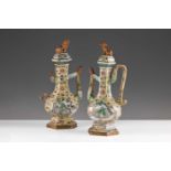 A near pair of Chinese Famille Verte wine ewers, Qing, Kangxi, the hexagonal covers surmounted by
