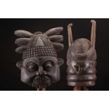 A Grasslands helmet mask, Cameroon, with a spiked and diced coiffure leading to an aperture at the