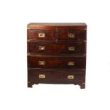An early 19th-century mahogany two section bow-fronted caddy topped the campaign chest of drawers.