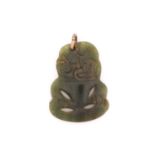 A New Zealand Maori Tiki greenstone pendant, of typical form with tilted head and pierced body, 3.