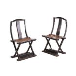 A pair of small Chinese black lacquer folding "travelling chairs" with arched cresting rails above