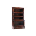 A Globe-Wernicke oak modular four-section bookcase with plain glazed doors, the base section with
