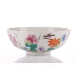 A Chinese famille rose bowl, the interior painted with a floral spray with rocks, the exterior