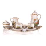 A late 19th or early 20th century Berlin porcelain tete-a-tete coffee set, each item painted with