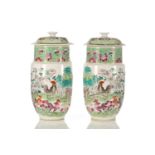 A pair of Chinese porcelain vases and covers, of cylindrical form tapering at the base, the covers