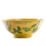 A Chinese porcelain yellow ground bowl, with green-painted decoration depicting figures in a