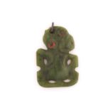A New Zealand Maori Tiki greenstone pendant, likely 19th century, with tilting head, red wax eyes