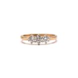 A 9ct gold and three-stone diamond ring, consisting of three brilliant diamonds with an estimated