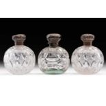A pair of Edwardian silver-mounted cut glass scent bottles, London 1905 (maker indistinct), together