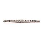 A Victorian diamond bar brooch navette shaped and set with twenty one old brilliant cut diamonds