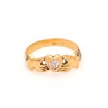 A Fede ring set with a diamond, depicting two hands holding a heart, symbolising faith and