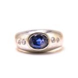 A sapphire and diamond gypsy ring, featuring a cushion-shaped sapphire with an intense and deep blue