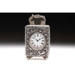A late Victorian miniature silver carriage clock; the circular white enamel dial with Roman