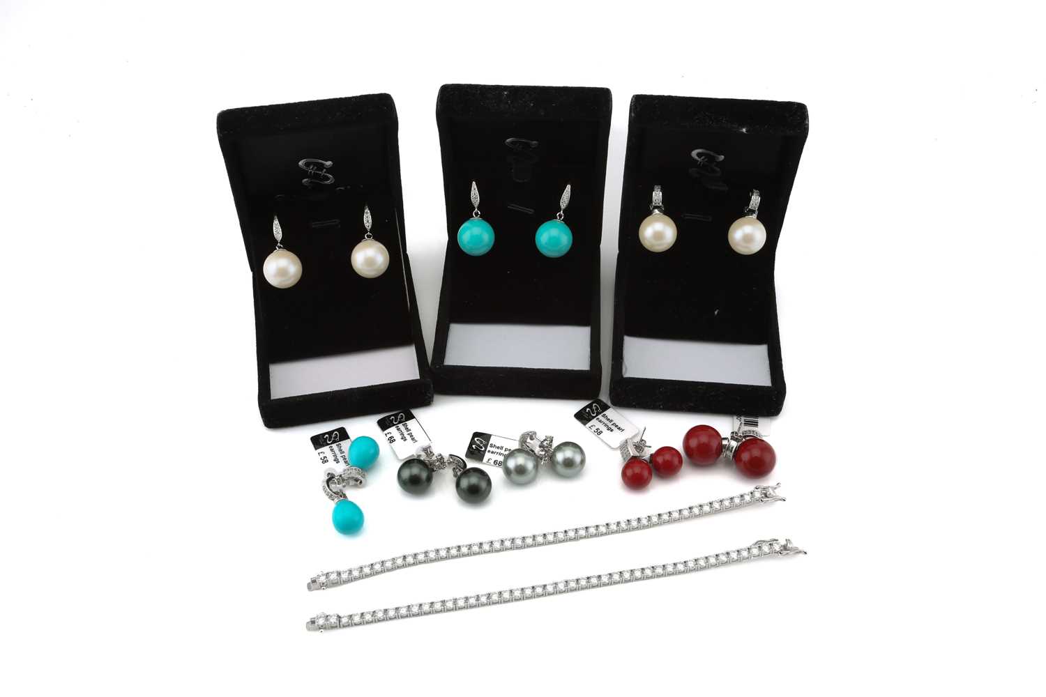 A lot consisting of 8 pairs of imitation enamel pearls and two cubic Zirconia line bracelets. The