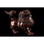 A Chinese bronze censer in the form of a temple lion, with scrolling mane and tail, the chest with
