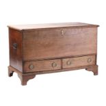 A late 18th-century mule chest with a hinged cover opening to reveal a drawer-fitted interior with a