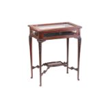 An Edwardian mahogany "Chippendale" style table vitrine with a shaped panel glazed top. on slender