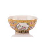 A Chinese porcelain bowl, painted with medallions of auspicious flowers and flanked by treasures,