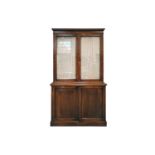 An Edwardian mahogany cupboard bookcase with a pair of plain glazed upper doors over a base with a