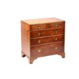 A small good quality yew wood campaign-style chest of drawers with brass banding and recessed ring-