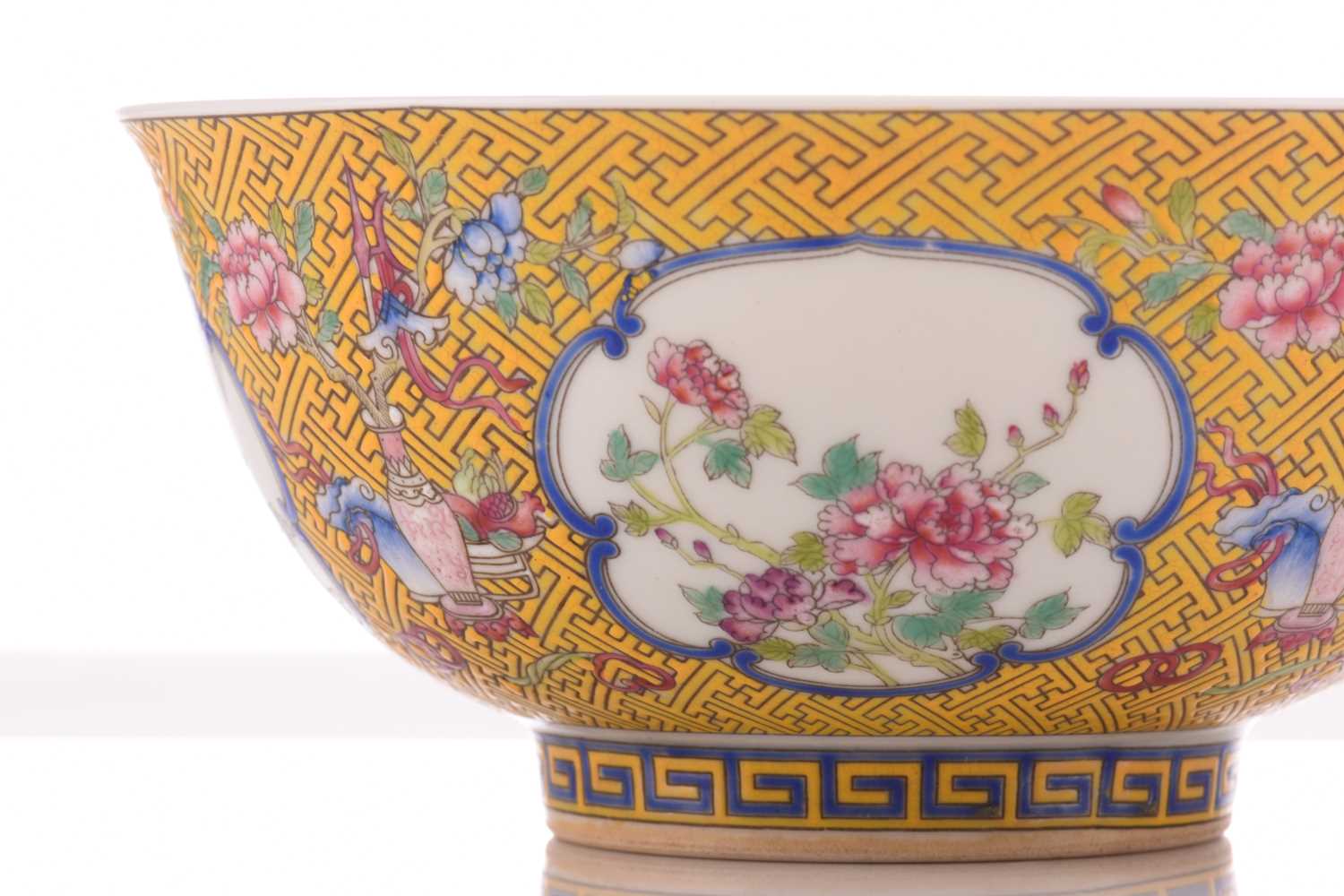 A Chinese porcelain bowl, painted with medallions of auspicious flowers and flanked by treasures, - Image 2 of 4