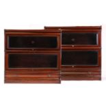 A pair of two-section mahogany Globe Wernicke modular bookcases with bevelled edge plain glazing and