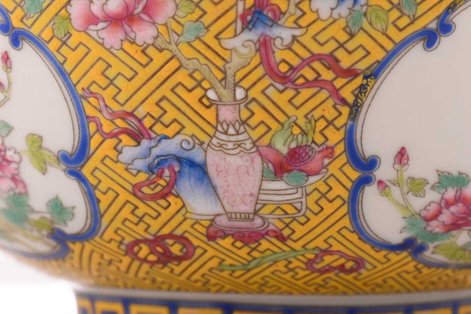 A Chinese porcelain bowl, painted with medallions of auspicious flowers and flanked by treasures, - Image 3 of 4
