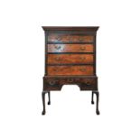 A George III mahogany on the associated chest on stand, the upper section with chinoiserie blind