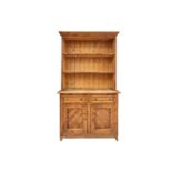 An architectural stripped pine dresser and integral rack, 19th century and later adaptations. With