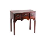 A Geoge II/III mahogany kneehole lowboy with three short drawers over a shaped frieze on shaped