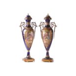 A pair of large Sevres style vases and covers, late 19th or early 20th century, each with a