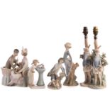 Two Lladro figural table lamp bases, each modelled with a girl holding a basket, 39 cm high,
