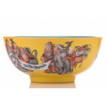 A Chinese porcelain bowl, painted with scholars reading scroll with boy attendants, on a yellow