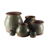 Four Sawankhalok celadon food/storage jars, two jars with ribbed decoration, a further jar with