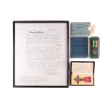 A King George VI & Queen Mary signed OBE document, framed, together with a Royal Mint cased MBE