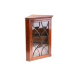 A George III oak single door hanging corner cupboard with elliptical glazing. 84 cm wide x 112 cm