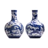 A pair of large Chinese blue and white porcelain bottle vases, 20/21st century. Each is decorated
