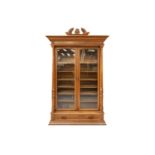 An early 20th century French/Swiss walnut two-door bookcase with a pair of plain glazed doors